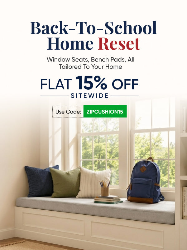 Promotional graphic for ZIPCushion products with the headline 'Back-To-School Home Reset' and 'FLAT 15% OFF SITEWIDE,' plus a green use-code box reading 'Use Code: ZIPCUSHION15.' The lower portion shows a window seat with pillows, a small book, and a blue backpack in a bright room.
