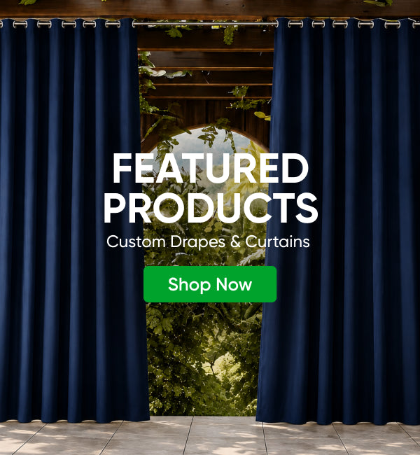 Two dark navy blue custom drapes hanging on a rod in front of an outdoor patio opening with greenery visible behind them. Large white text reads 'FEATURED PRODUCTS' with smaller text 'Custom Drapes & Curtains' and a green 'Shop Now' button overlay.