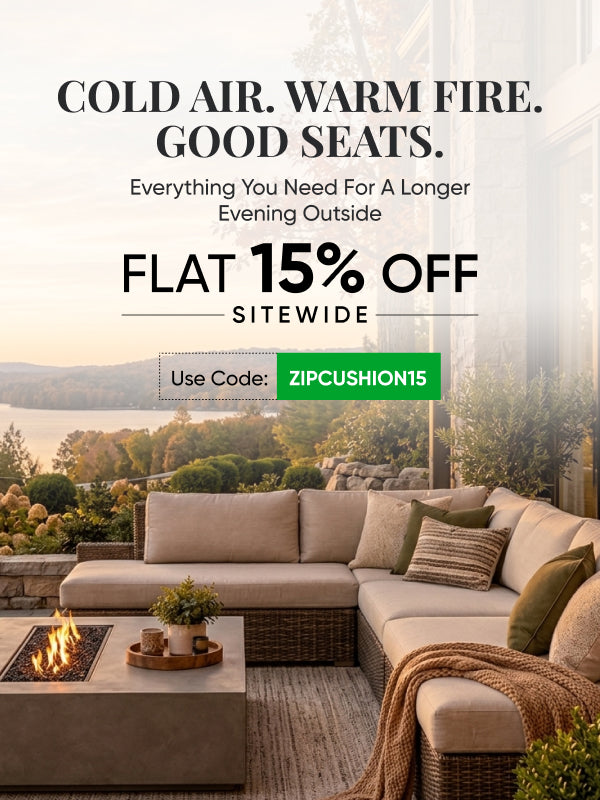 Beige outdoor sectional with fire pit table overlooking a sunset lake, autumn foliage. Use code ZIPCUSHION15 for 15% off