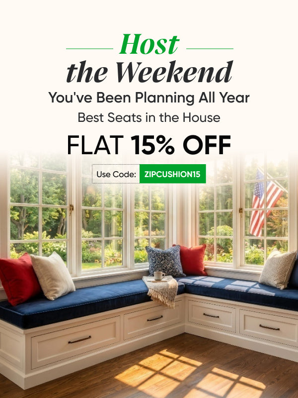 Memorial Day weekend sale mobile banner featuring a navy window seat with colorful indoor cushions and an American flag view, promoting flat 15% off with code ZIPCUSHION15