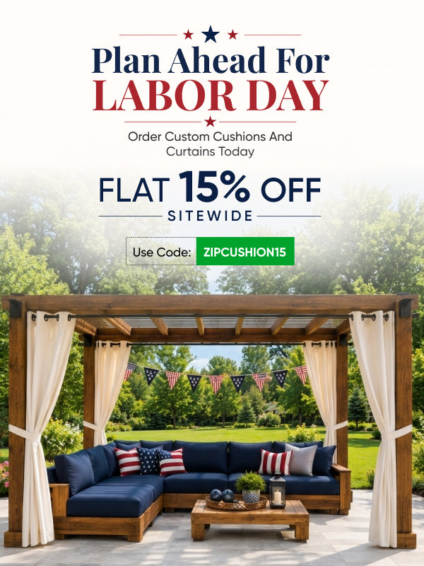 Labor Day promotional banner for ZipCushion featuring a wooden patio cabana with navy blue sectional cushions and cream curtains, set against a green garden background with text offering a flat 15% off sitewide.
