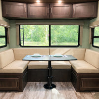 Comfortable RV dining space with forest view