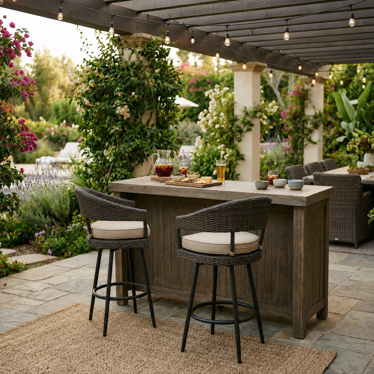 Outdoor patio bar with wicker chairs, beige cushions, string lights, and lush garden greenery - view 3